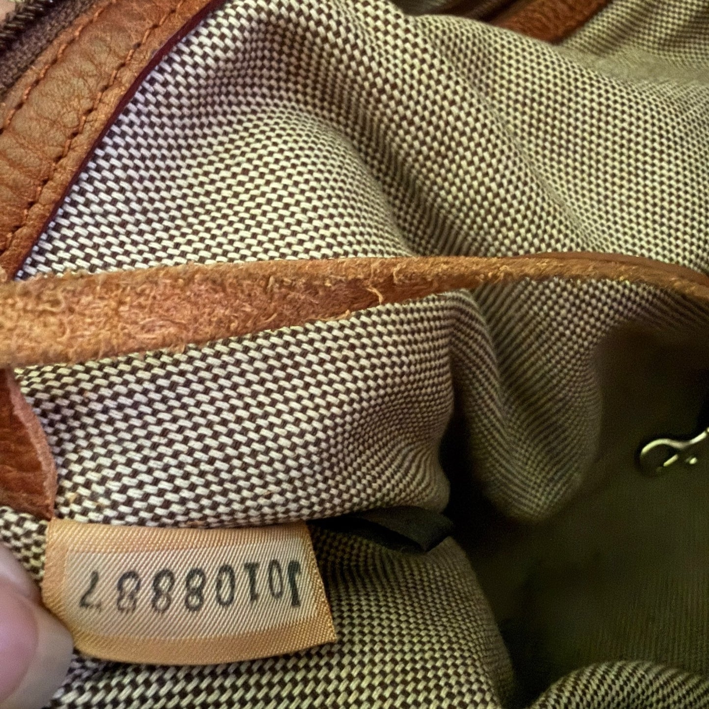 Close-up of a textured fabric surface with a visible brand label with serial number.