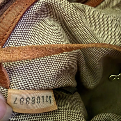 Close-up of a textured fabric surface with a visible brand label with serial number.