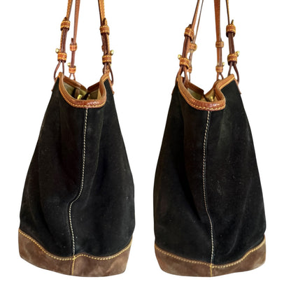 Side view of Black shoulder bag with brown leather accents on a white background