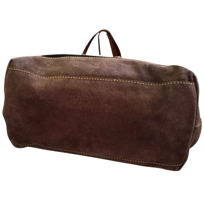 Bottom of black and brown purse with a bottom view on a white background