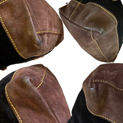 Close-up of brown leather corners of purse with gold stitching on a white background