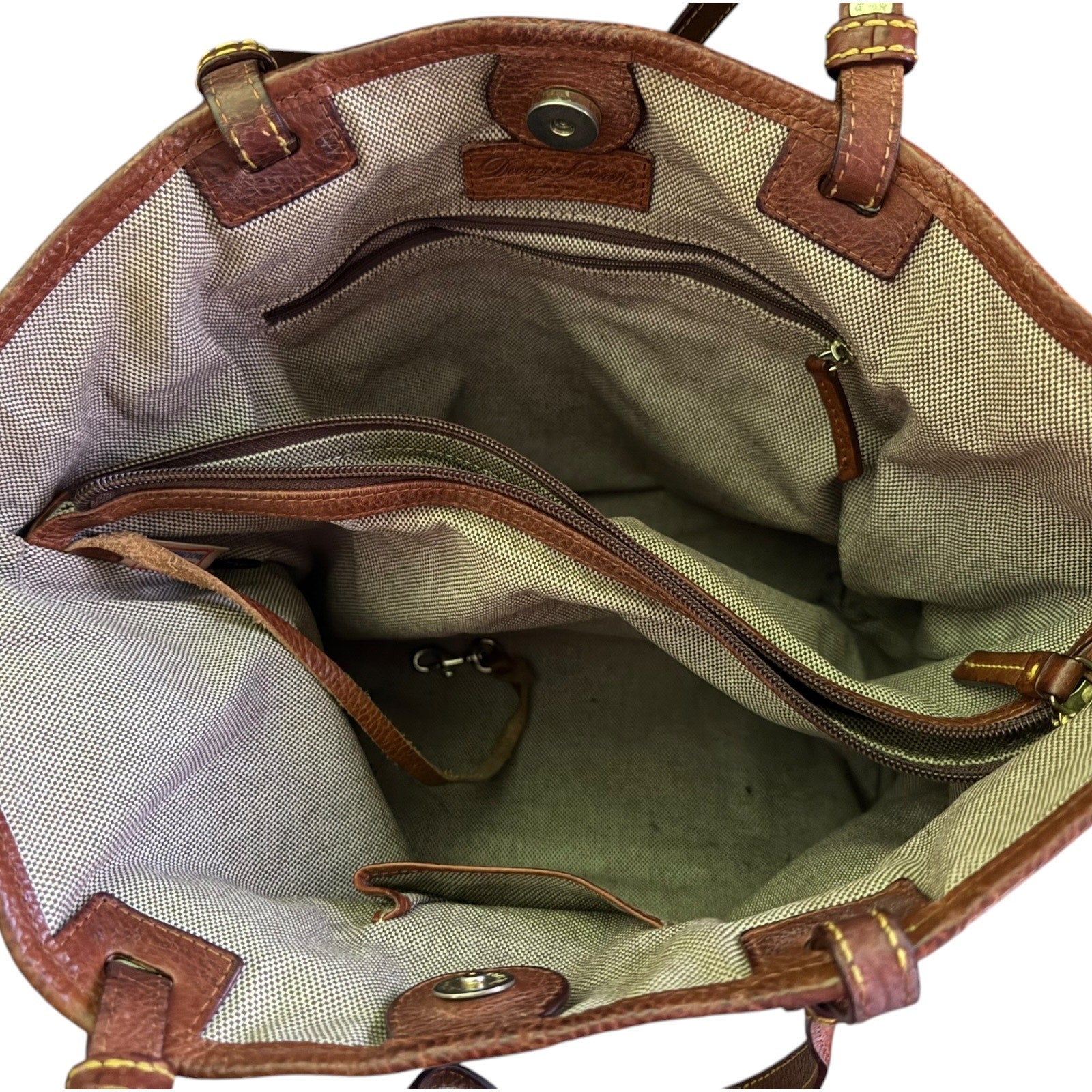 Open bag with brown leather accents on a white background