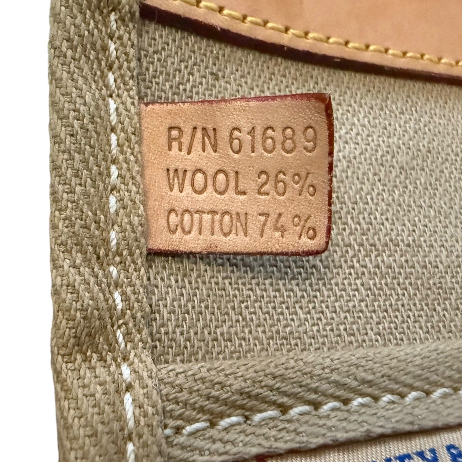 Textile label on a fabric surface with material composition details.