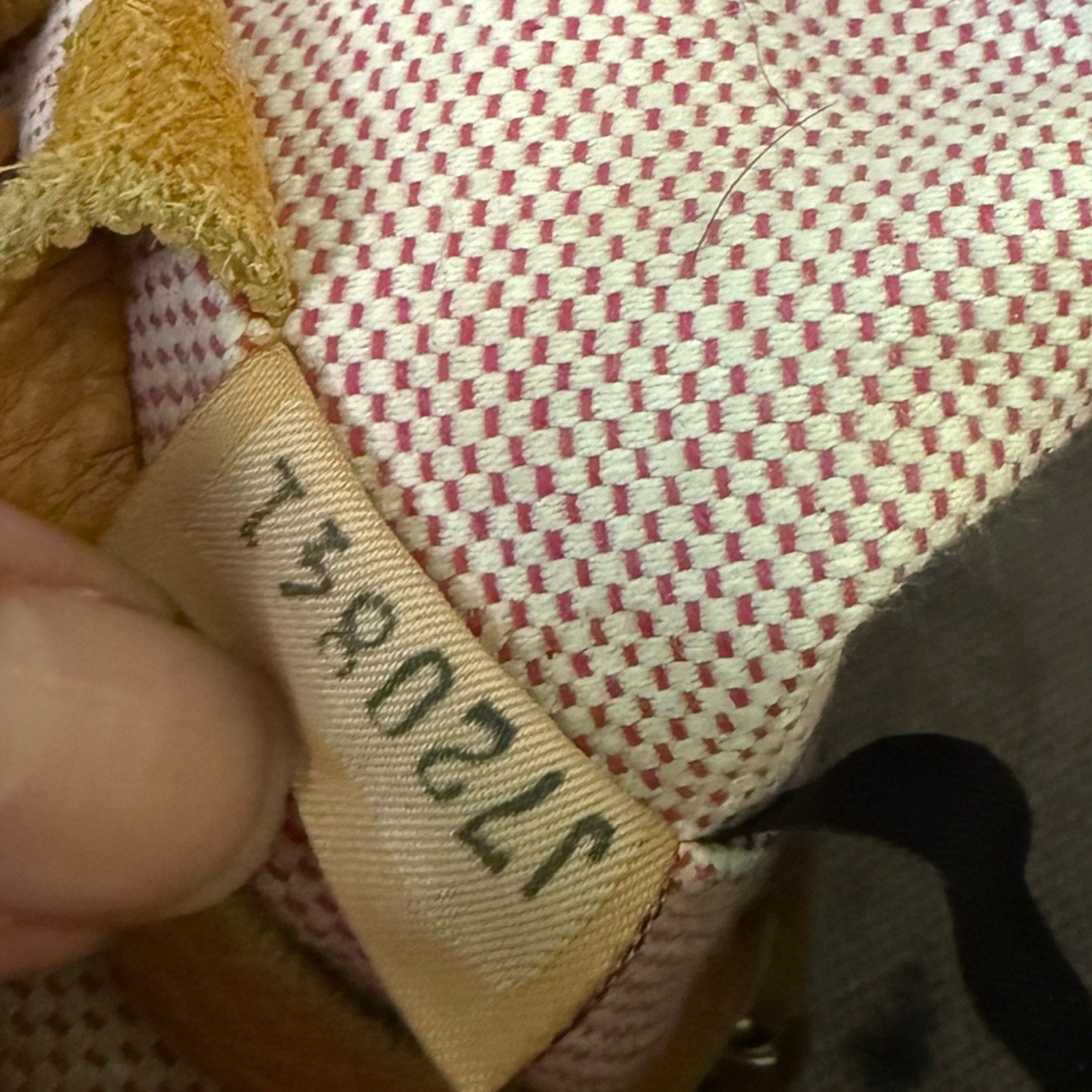 Close-up of a textured fabric surface with a visible tag number.