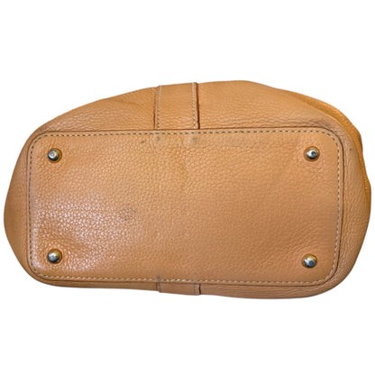 Brown leather handbag with gold studs on a white background