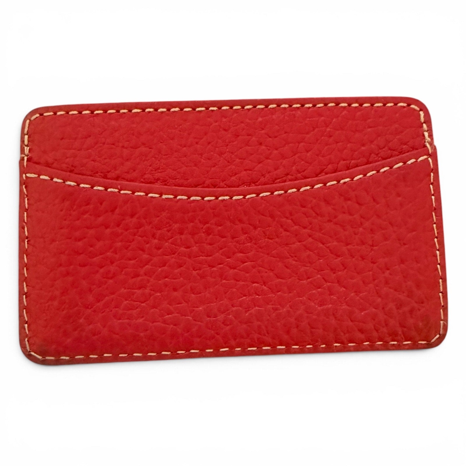 Red leather cardholder with white stitching on a white background