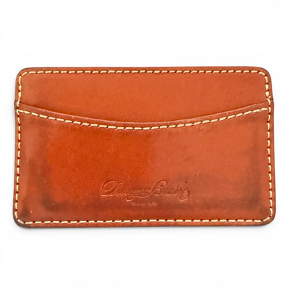 Brown leather cardholder with visible stitching on a white background