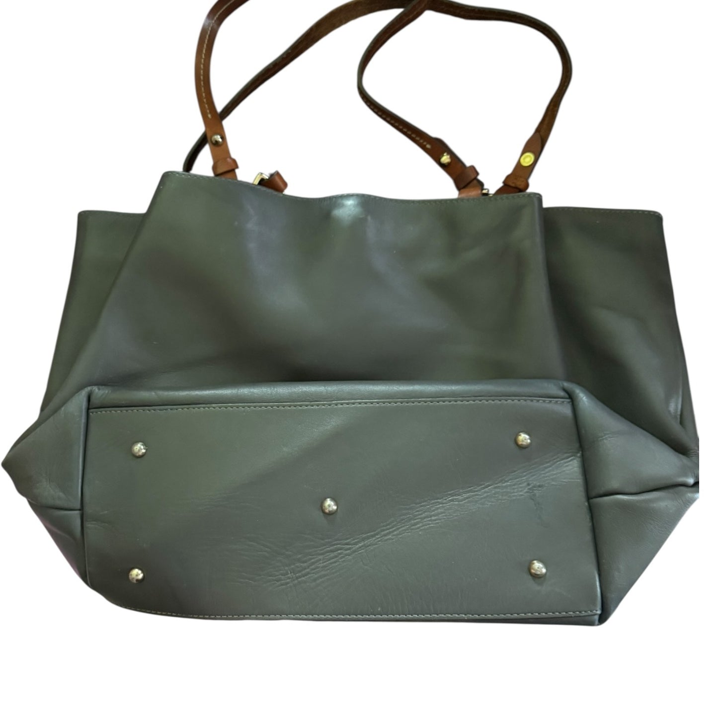Gray handbag laying down showing bottom with brown handles on a white background