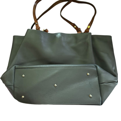 Gray handbag laying down showing bottom with brown handles on a white background