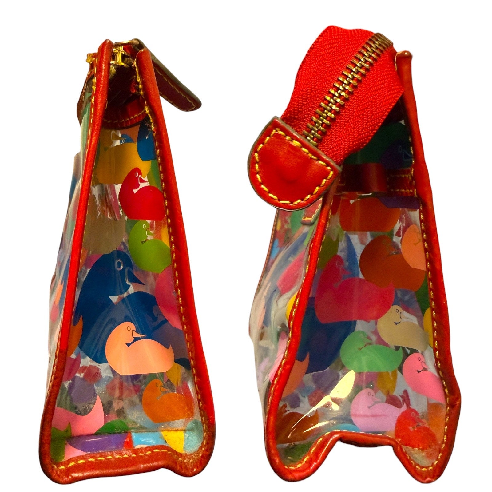 Side view of Transparent bag with colorful animal prints and red zipper on a white background
