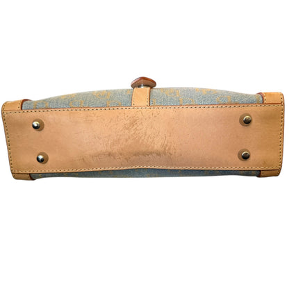 Handbag with beige leather with issues and blue fabric on a white background