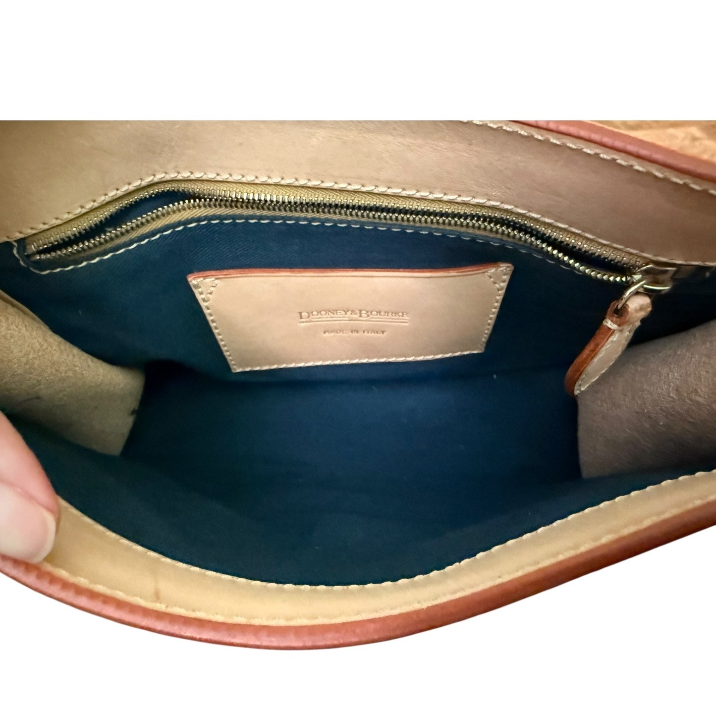 Close-up of a leather handbag interior with visible brand name.