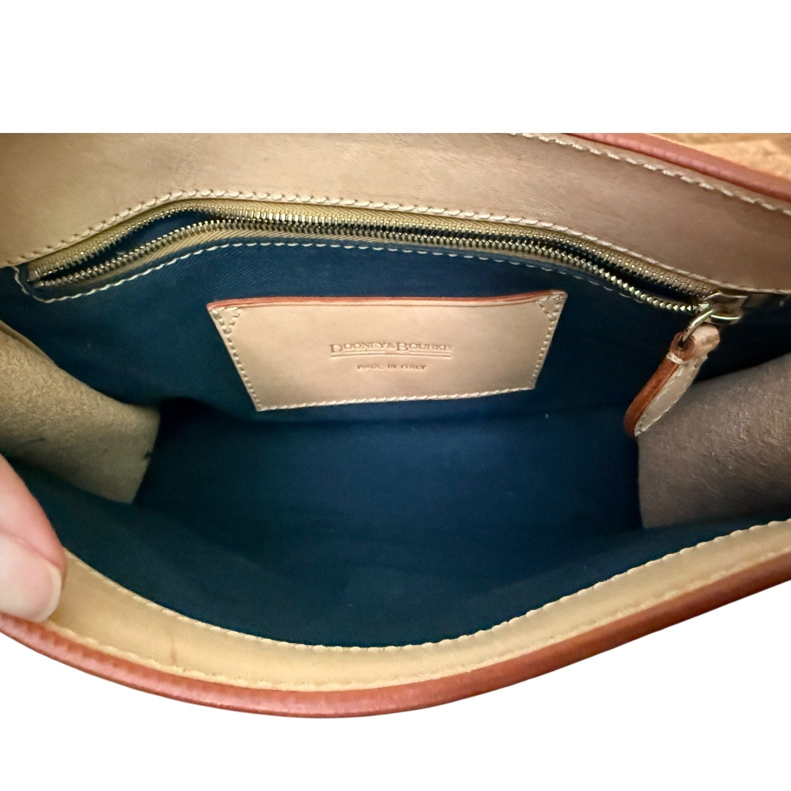Close-up of a leather handbag interior with visible brand name.