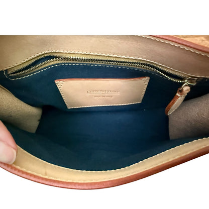 Close-up of a leather handbag interior with visible brand name.