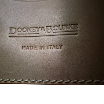 Brown leather surface with 'Dooney & Bourke' and 'Made in Italy' embossed text.