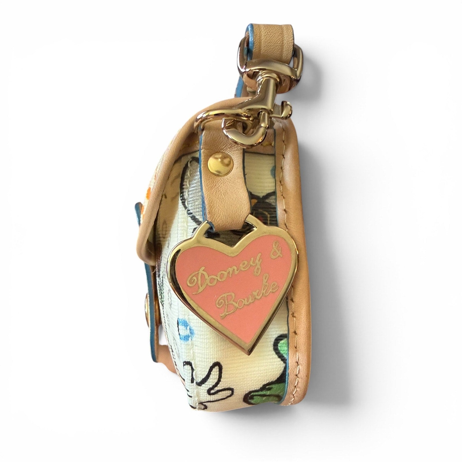 Side view of wristlet with heart-shaped tag on a white background