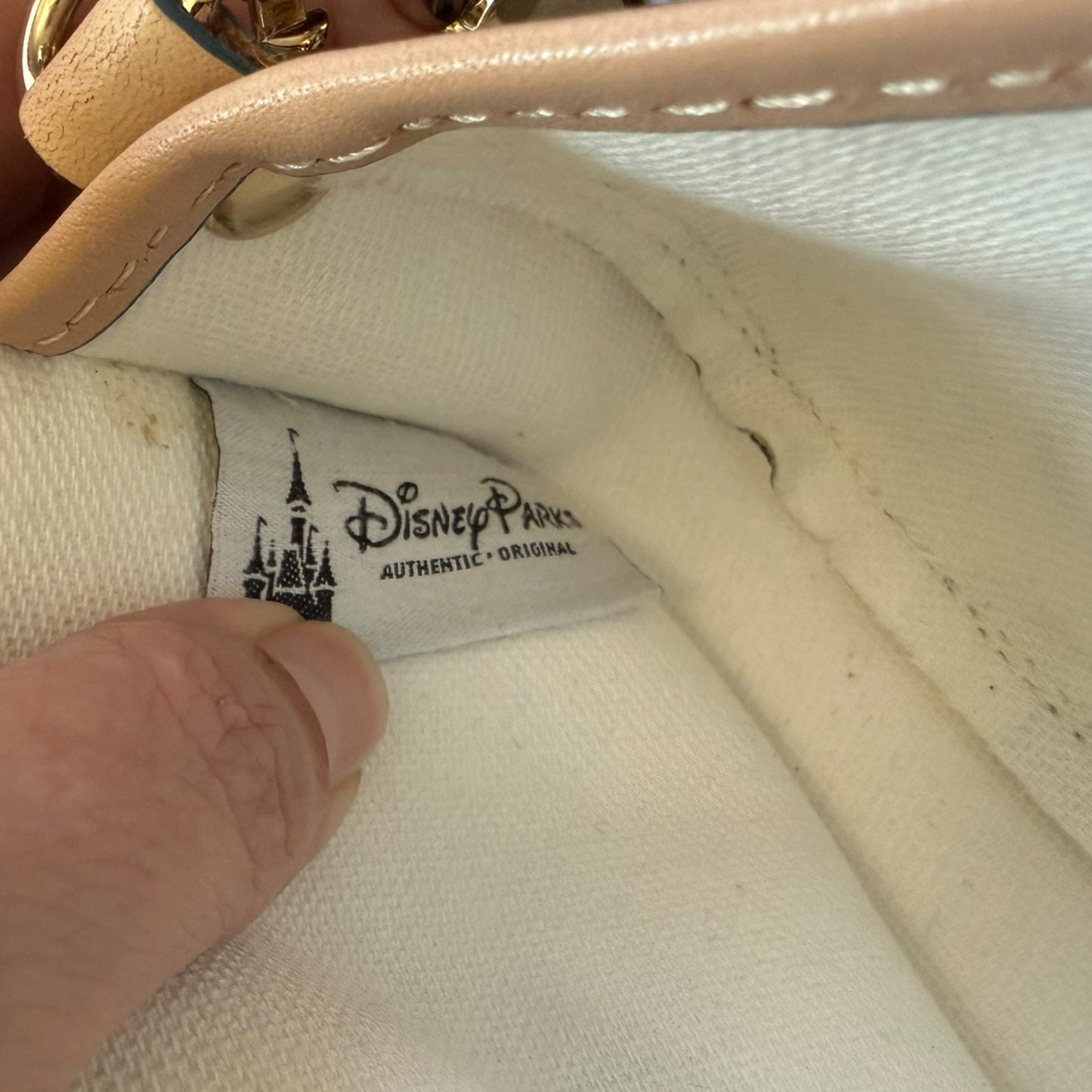 Close-up of a Disney Parks label on a interior of bag.