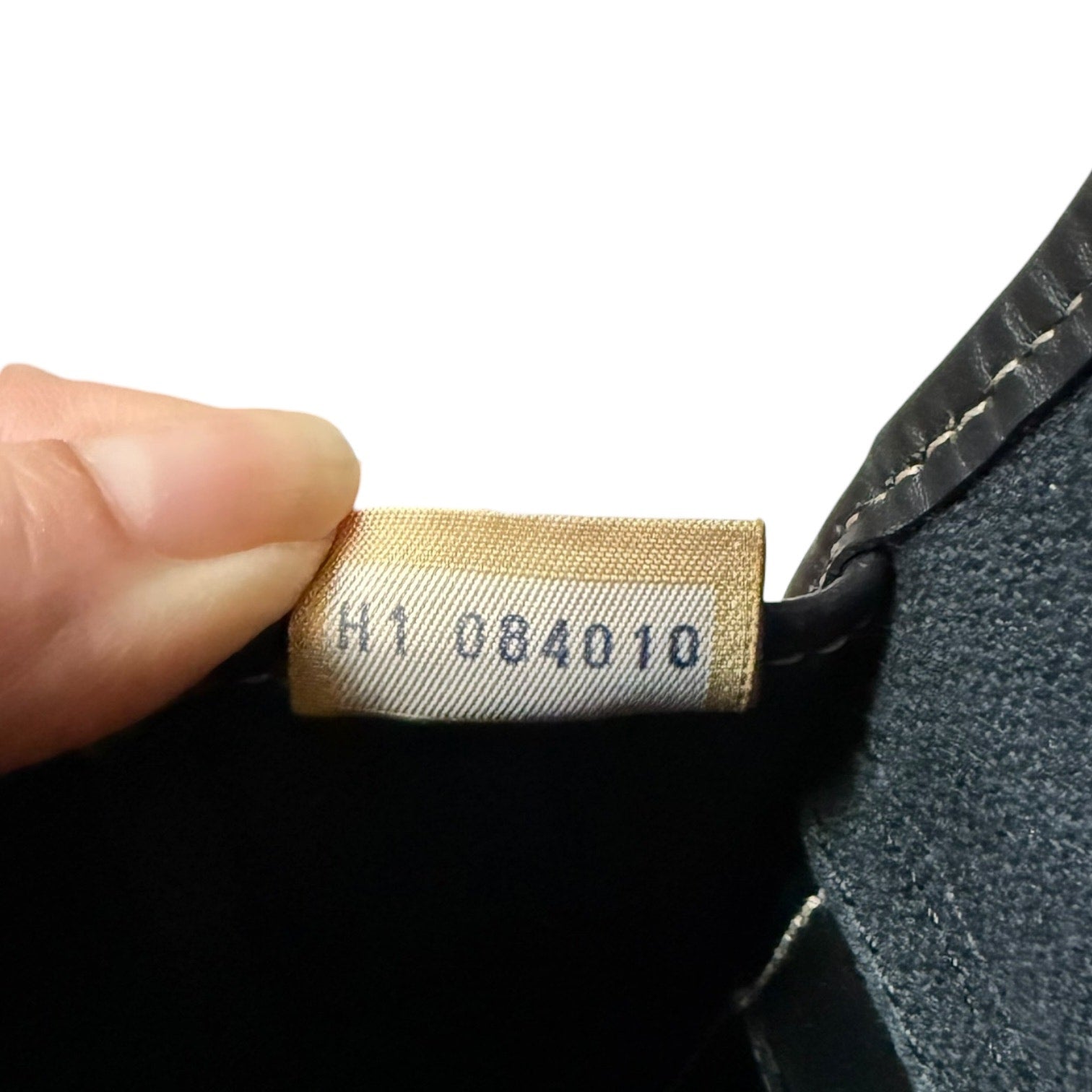 Close-up of a product tag with numbers on a textured surface
