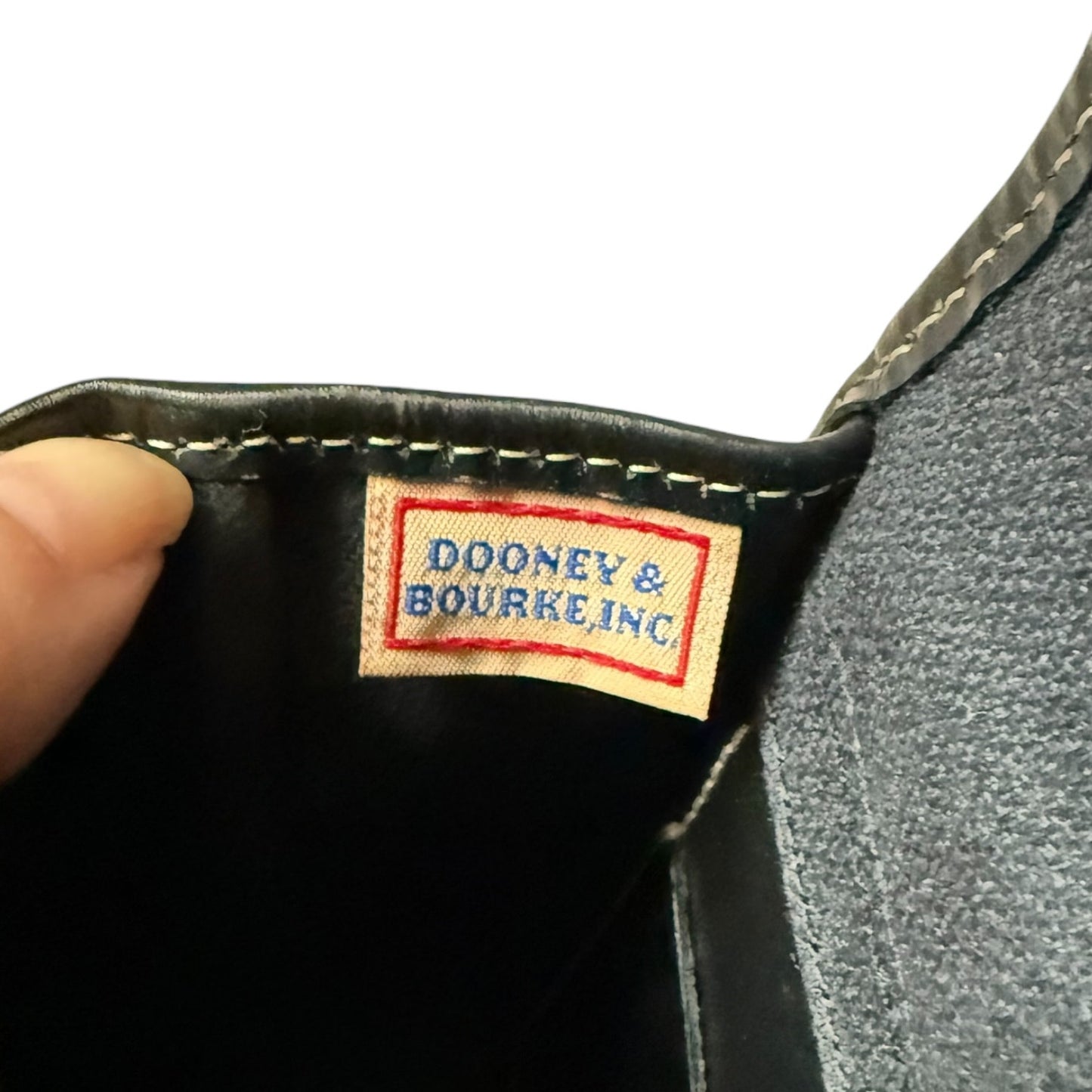 Dooney & Bourke label on a black leather product
