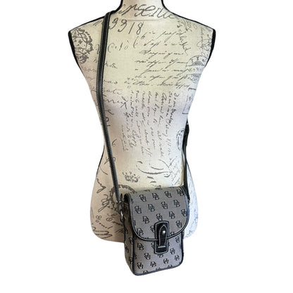 Mannequin torso with a patterned gray & black crossbody bag on a white background