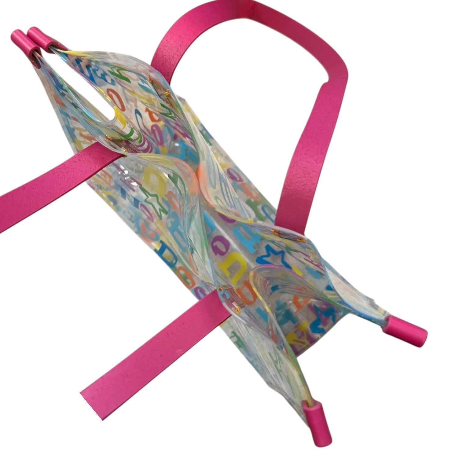 Top view of Colorful bag with letter patterns on pink straps against a white background