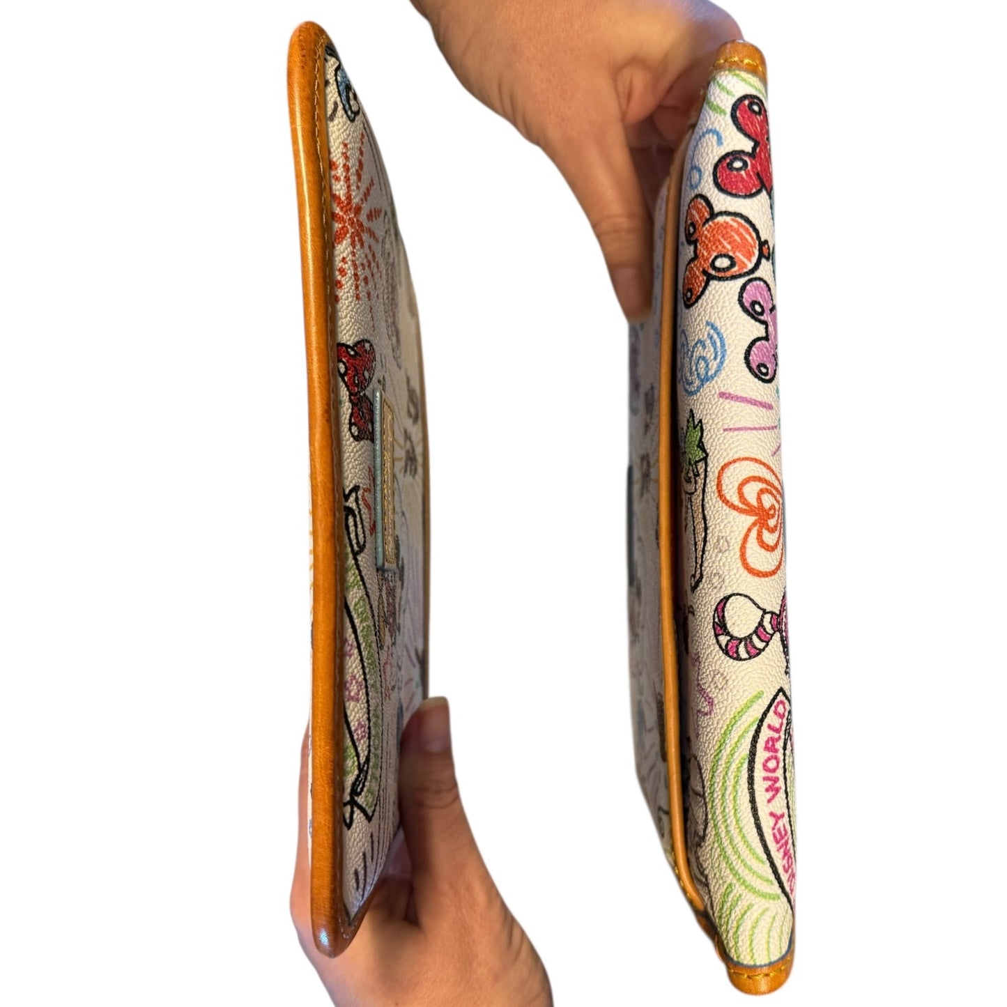 Top and bottom of pouch held by a hand against a white background