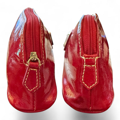 Side view of red pouche with gold accents on a white background