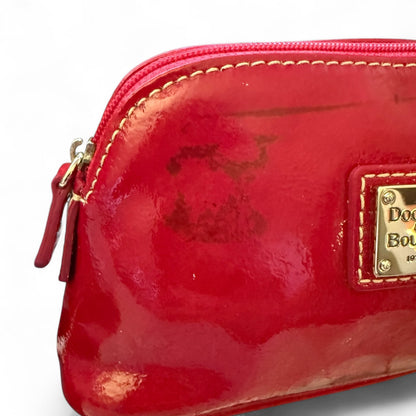 Red patent leather pouch with issue and logo on a white background