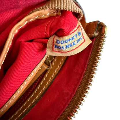 Close-up of a red interior with 'Dooney & Bourke' label on a white background