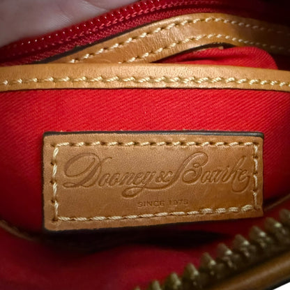 Dooney & Bourke logo on a red interior with brown leather trim