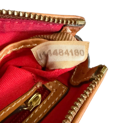Close-up of a red interior on handbag with serial number on tag