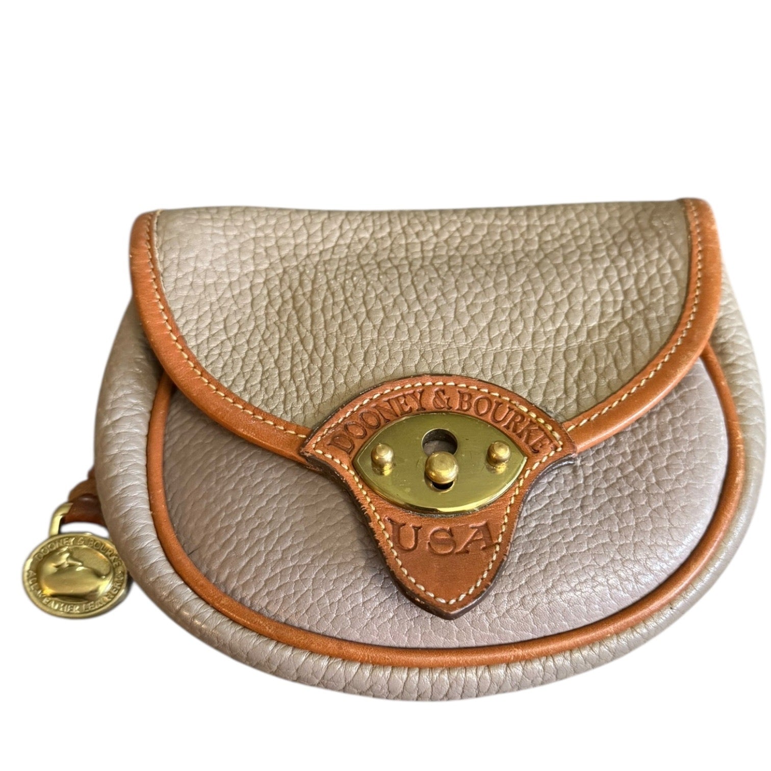 Front of Small leather pouch with gold accents and 'Dooney & Bourke' branding on a white background