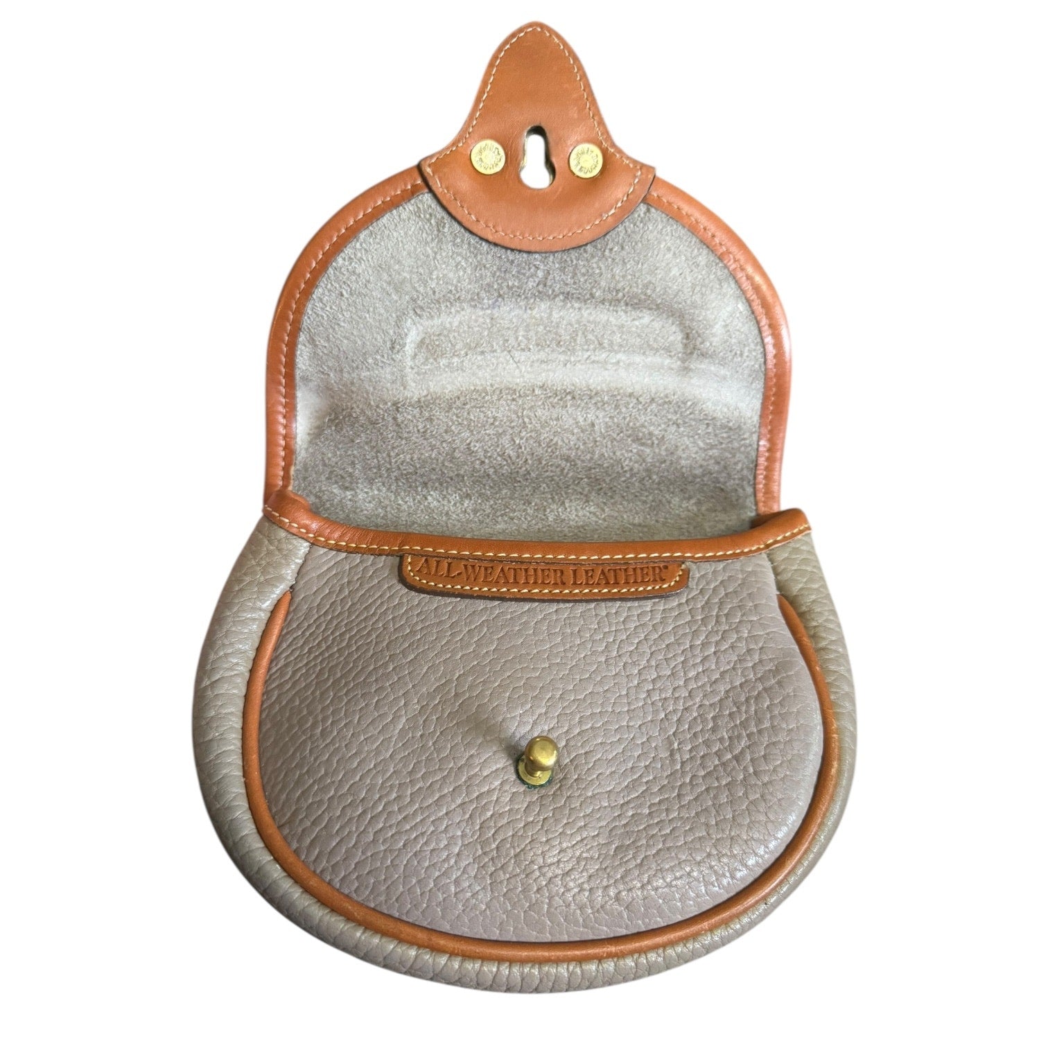 Interior of Round leather pouch with brown trim and visible brand name on a white background