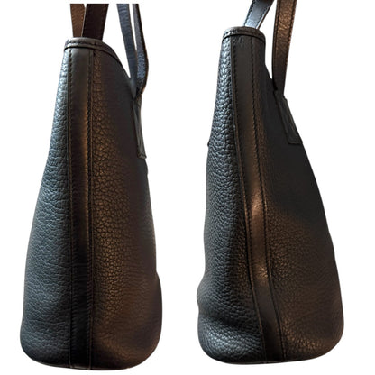 Side view of black leather handbag on a white background