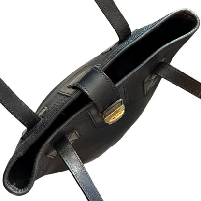 Top of black leather purse with gold buckle on a white background