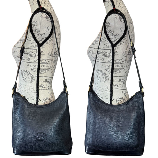 Front and back of black handbag displayed on mannequin busts with a white background.