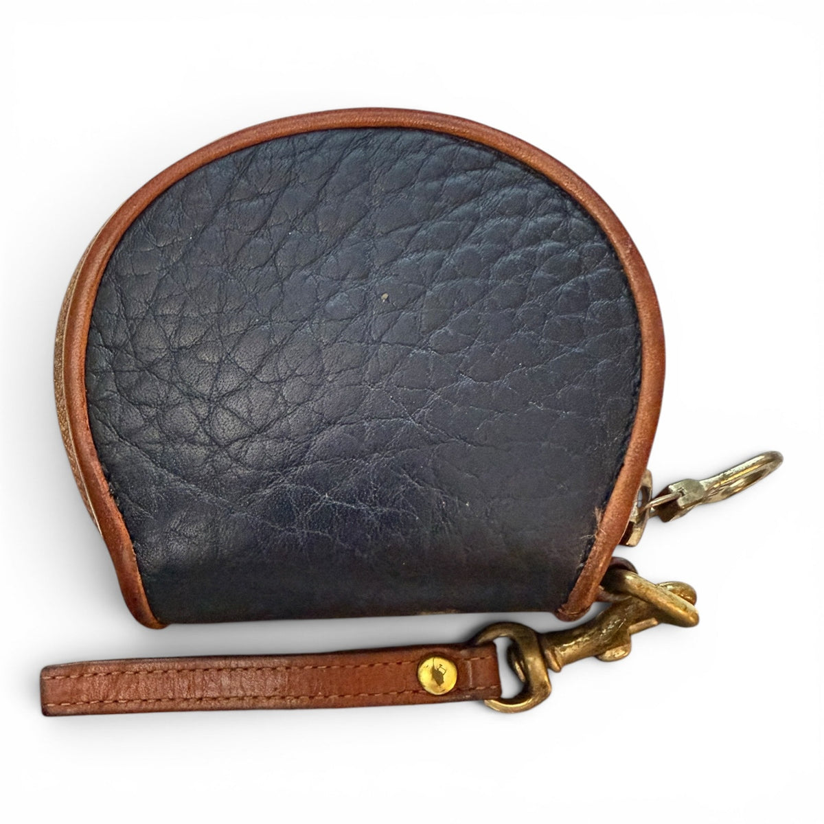 Black leather coin purse with brown strap and gold clasp on a white background