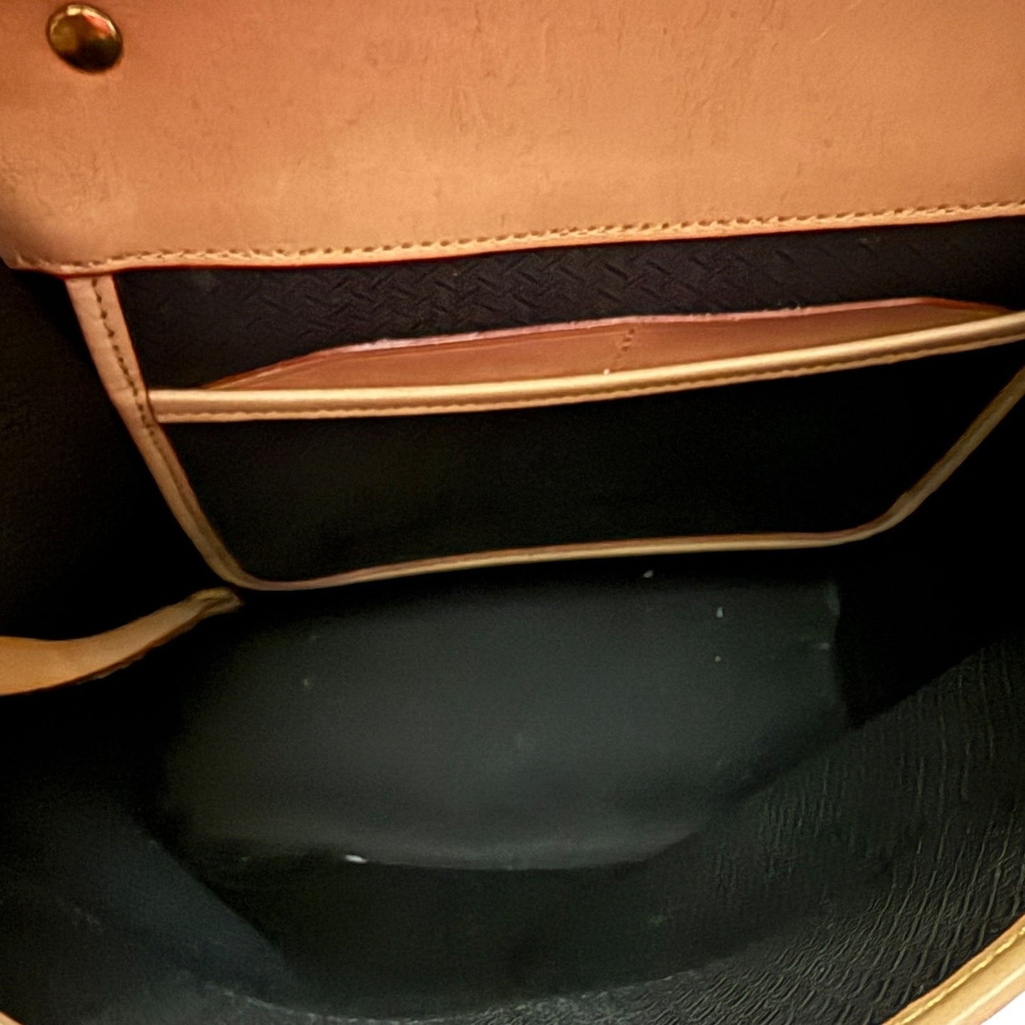 Black interior of red purse handbag with a black interior.