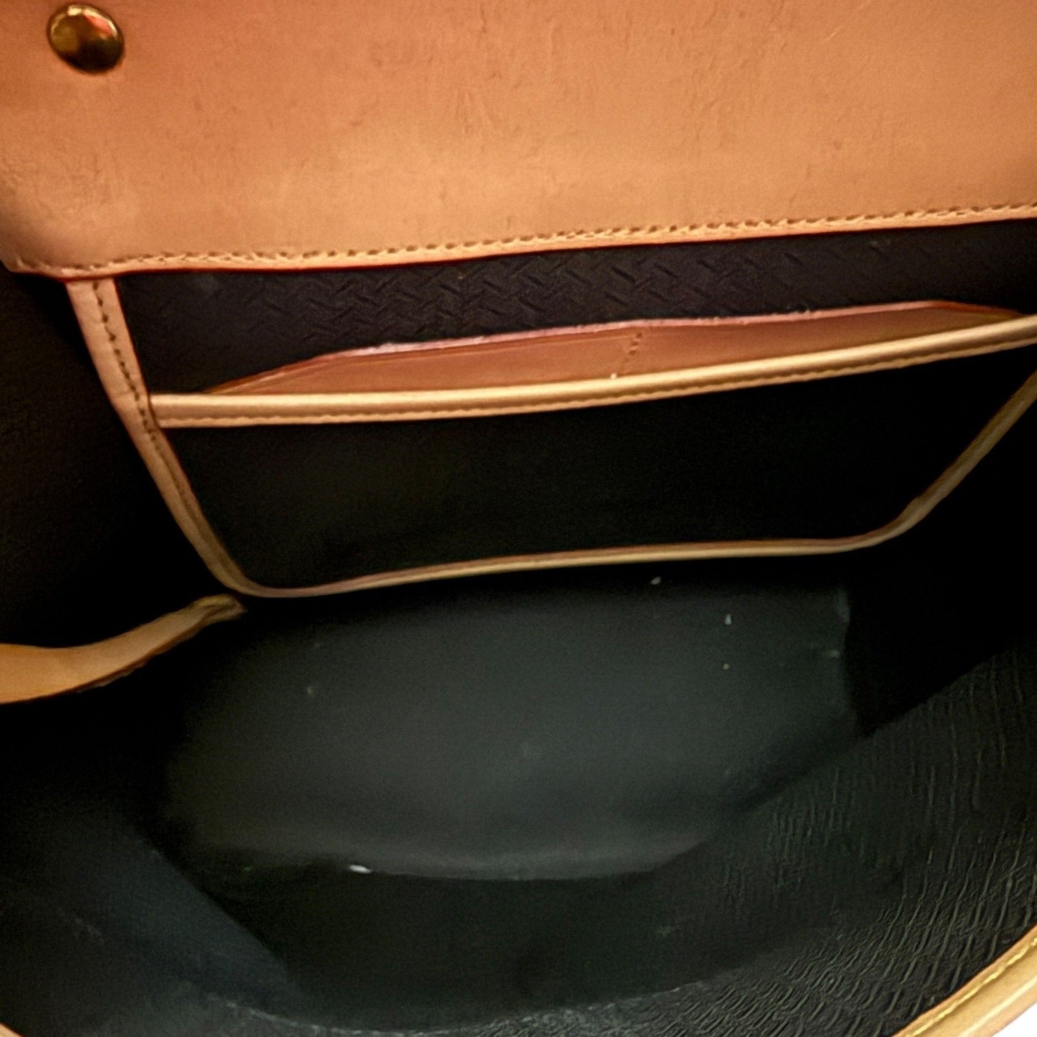 Black interior of red purse handbag with a black interior.