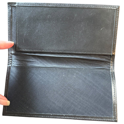Black leather interior of checkbook wallet held open to show interior