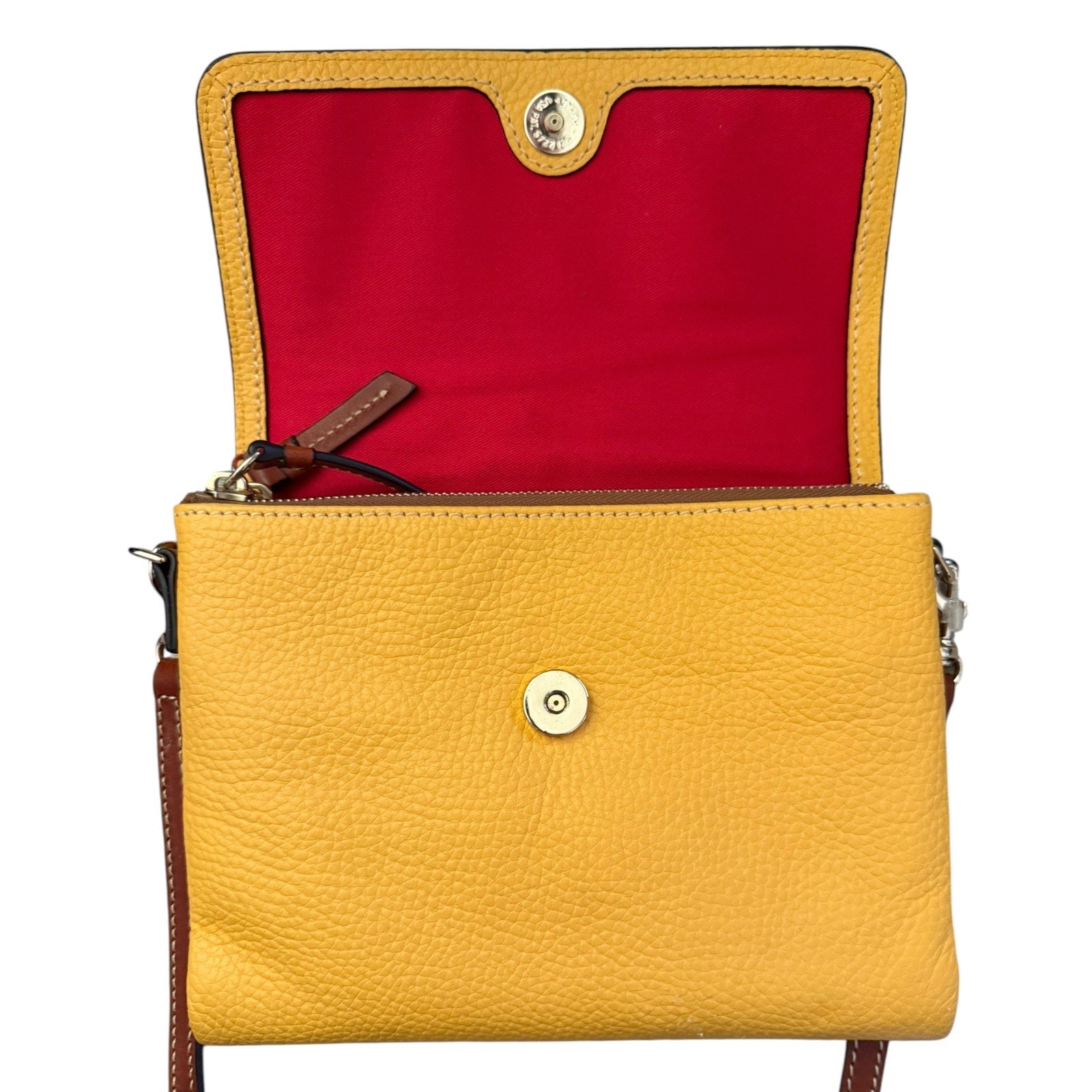 A yellow pebbled leather crossbody bag shown open, revealing a bright red interior lining and gold-tone hardware.