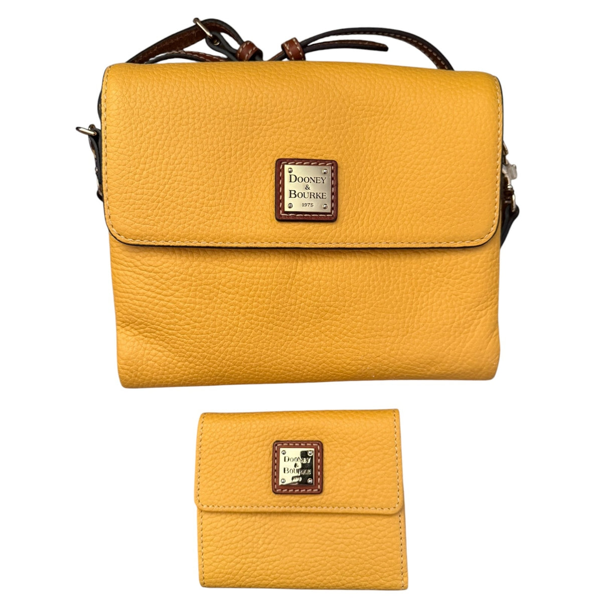 A yellow pebbled leather crossbody bag with a matching wallet, both featuring a brown leather and silver logo patch .