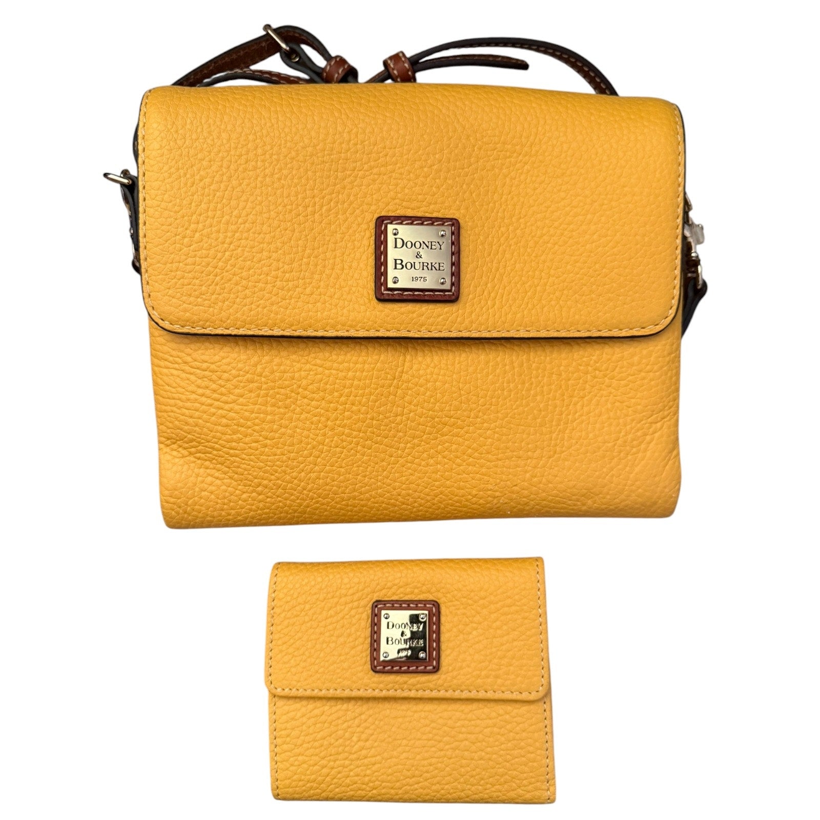 A yellow pebbled leather crossbody bag with a matching wallet, both featuring a brown leather and silver logo patch .