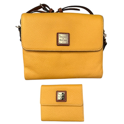 A yellow pebbled leather crossbody bag with a matching wallet, both featuring a brown leather and silver logo patch .