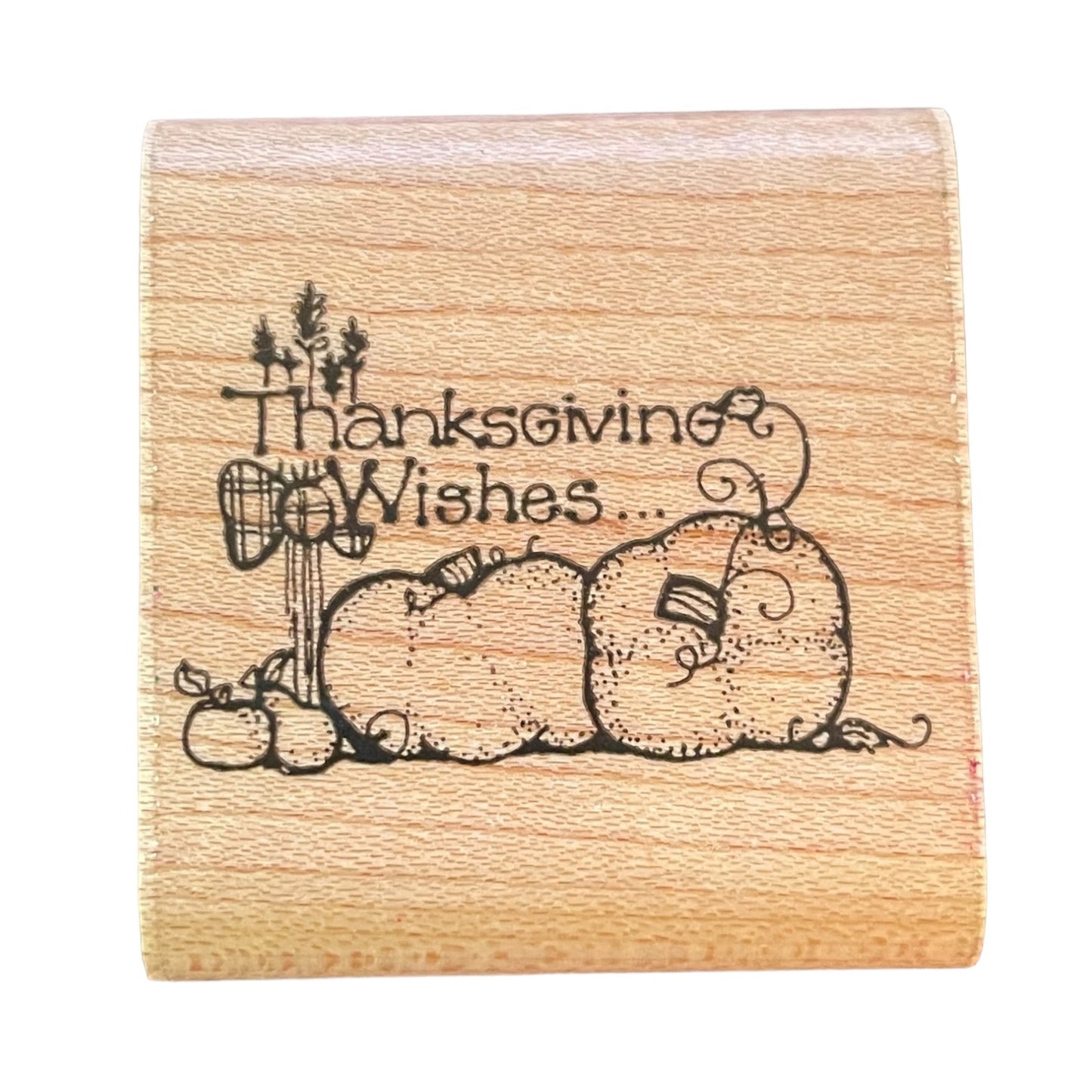 Wooden stamp with 'Thanksgiving Wishes' text and pumpkin design on a white background