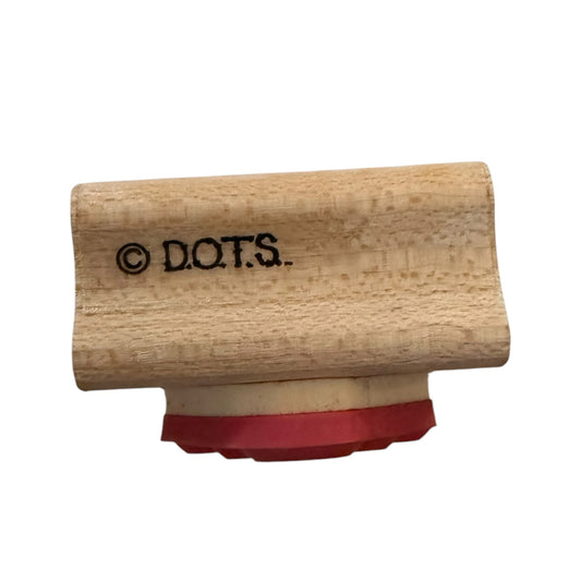 A wooden rubber stamp with the brand name D.O.T.S.