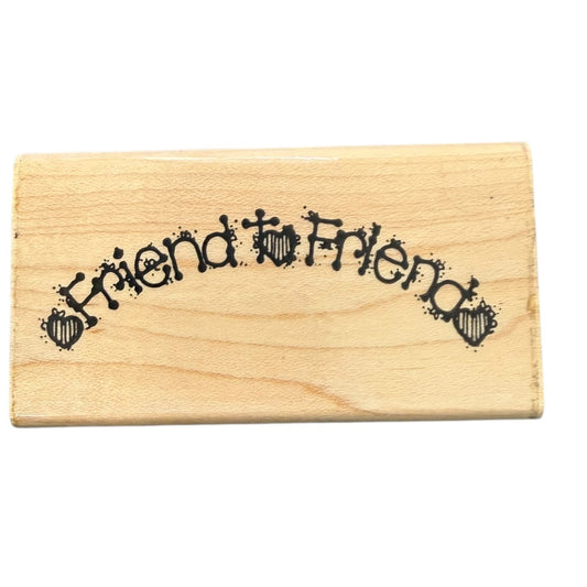 Wooden stamp with 'Friend to Friend' text on a white background