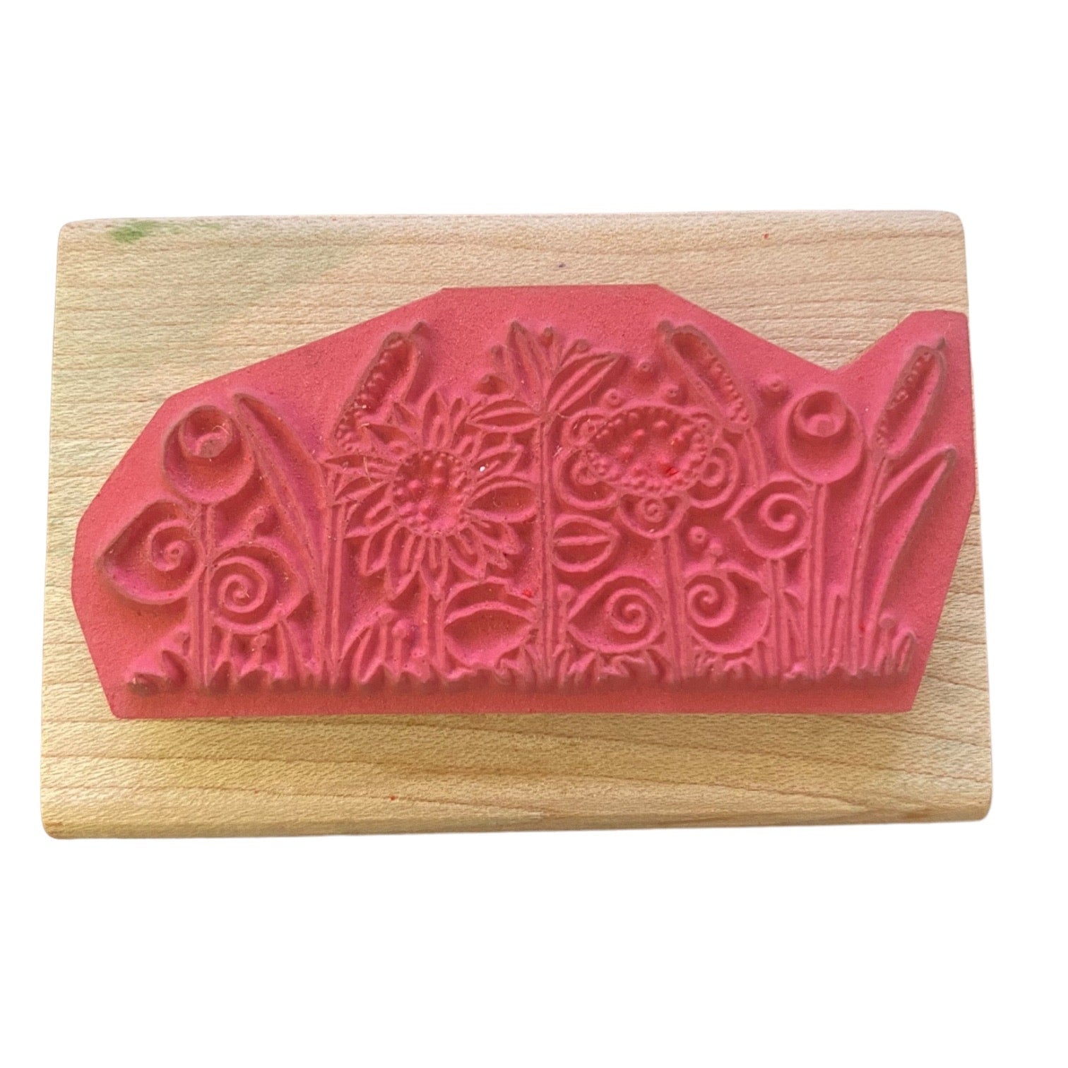 Wooden stamp with floral design on a white background