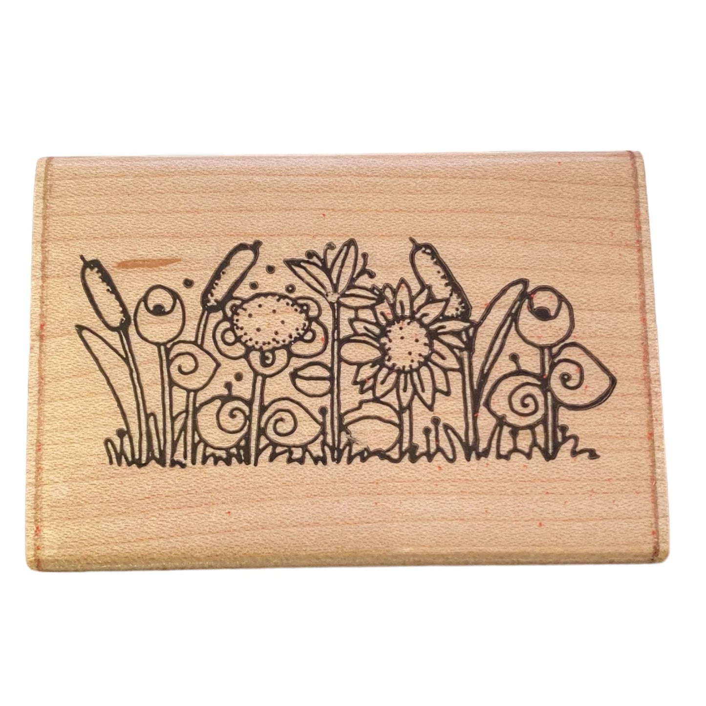 Wooden stamp block with floral design on a white background