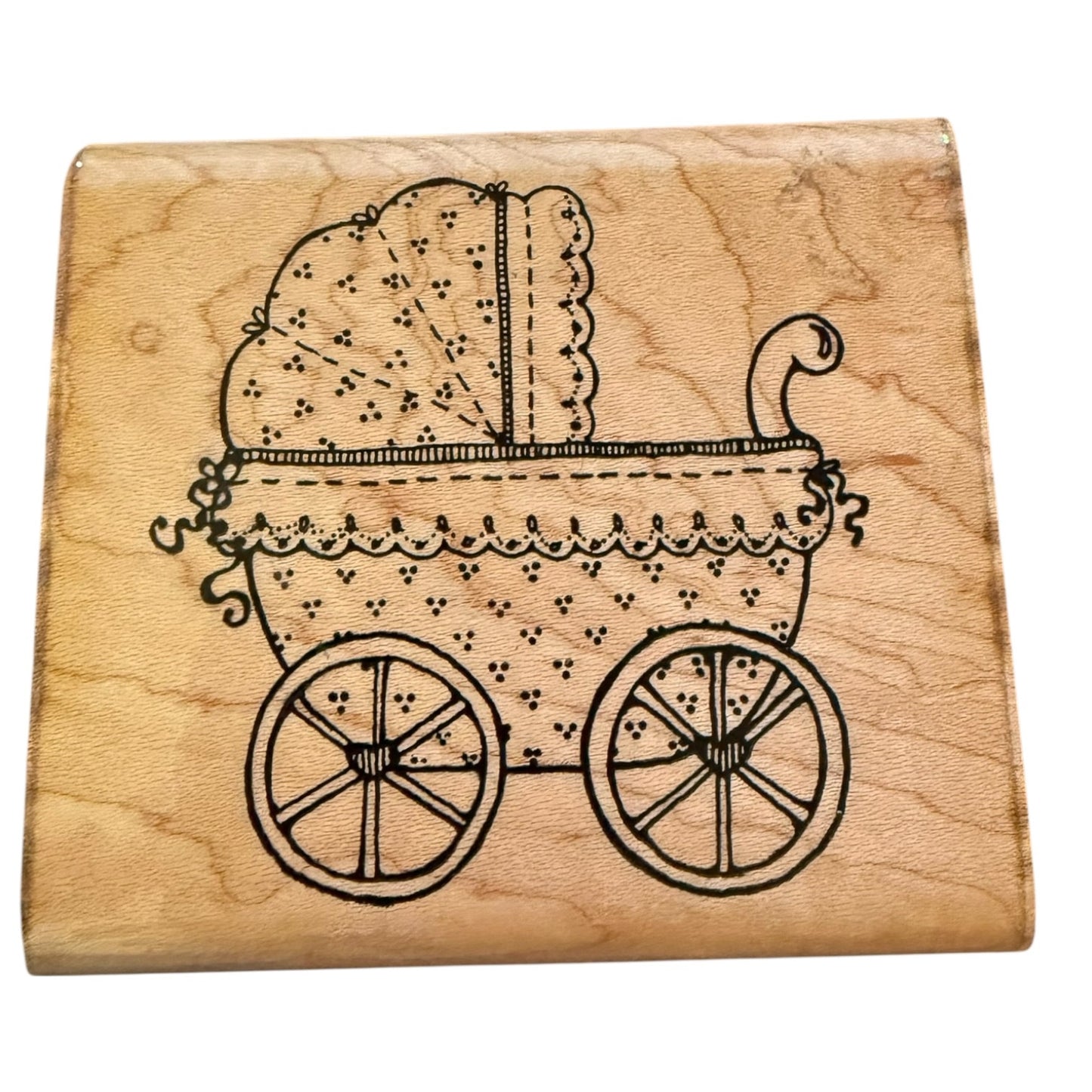 Wooden stamp with a image of a vintage baby carriage on a white background